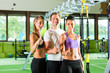 People in sport gym on suspension trainer