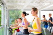 Photo: People in sport gym on treadmill running People in sport gym on treadmill running