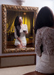 Sensual  womaan in white dress looking mirror with a wine glass