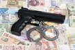 Foto: Currency from world with handcuffs and handgun Currency from world with handcuffs and handgun