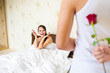 Photo: man holding a rose behind his back in bedroom man holding a rose behind his back in bedroom