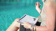 Video: Closeup of businesswoman with documents sitting by the swimming- Closeup of businesswoman with documents sitting by the swimming-