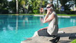 Video: Young businesswoman sitting by the poolside with cellphone Young businesswoman sitting by the poolside with cellphone