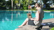 Video: Businesswoman working on laptop computer by the poolside Businesswoman working on laptop computer by the poolside