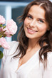 woman with bouquet of flowers at home