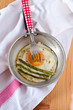 Organic asparagus and eggs in a frying pan