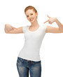 Photo: woman in blank white t-shirt pointing at herself woman in blank white t-shirt pointing at herself