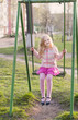 girl on swing in spring park