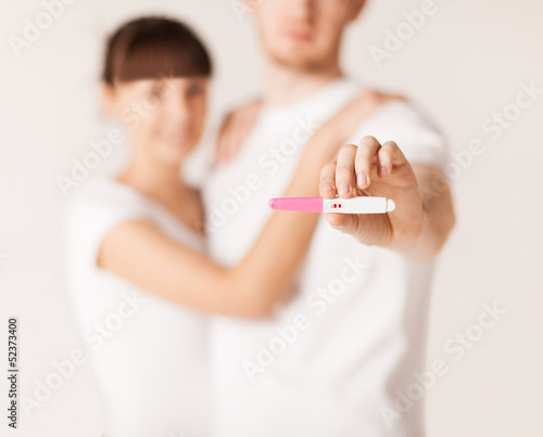 Photo: woman and man hands with pregnancy test woman and man hands with pregnancy test