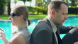 Video: Business couple with tablet and documents sitting by the swimmin Business couple with tablet and documents sitting by the swimmin