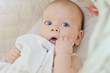 blue eyed baby in crib