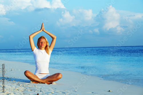 Photo: yoga woman on sea coast yoga woman on sea coast
