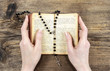 Hands holding the Bible and praying with a rosary
