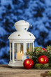 Beautiful white lantern on snowy evening landscape. Christmas de