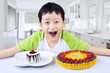 Photo: Boy laughing with desserts at home Boy laughing with desserts at home