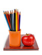 Workbook and  color pencils with apple