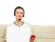 A woman working on a laptop, holding a red card