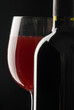 bottle with red wine and glass