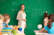 Teacher by blackboard