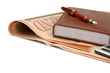 Photo: A diary and a fountain pen placed on a financial newspaper. A diary and a fountain pen placed on a financial newspaper.