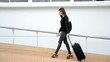 Young business woman on the phone and going to flight