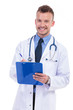 smiling young male doctor writing his notes