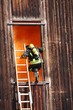 brave firefighters with oxygen cylinder goes into a house throug