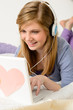 Young teenage girl chatting on laptop