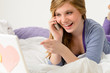 Laughing teenager relaxing by speaking on phone