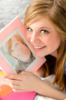 Teenage girl holding picture of her love