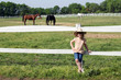 happy little girl with cowboy hat on ranch