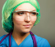 A female doctor in uniform, close-up, isolated on grey