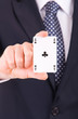 Businessman showing playing card.