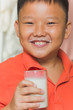 Photo: Young Asian boy with a glass of milk Young Asian boy with a glass of milk