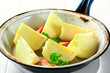 Fresh onion quarters in a pan