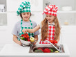 Kids washing vegetables in the kitchen