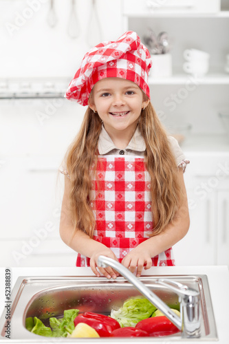 Photo: Little chef washing vegetables Little chef washing vegetables