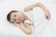 sick boy in white bed