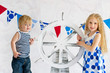 Cute sailor style kids holding steer wheel