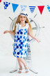 Elegant young girl on with wooden steer wheel