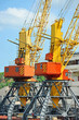 Port cargo crane over blue sky background