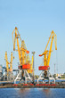 Port cargo crane over blue sky background