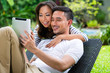 Photo: Asian couple outdoor with a tablet pc Asian couple outdoor with a tablet pc