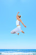 Photo: woman jumping on the beach woman jumping on the beach