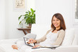 Young woman looking photos with digital tablet at home