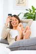 Young woman stretching comfortably on couch