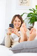 Young woman stretching comfortably on couch