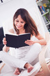 Young woman  reading a book in the room