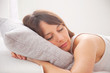 Portrait of a young woman sleeping on the bed
