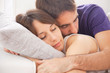 Portrait of a young couple sleeping on bed